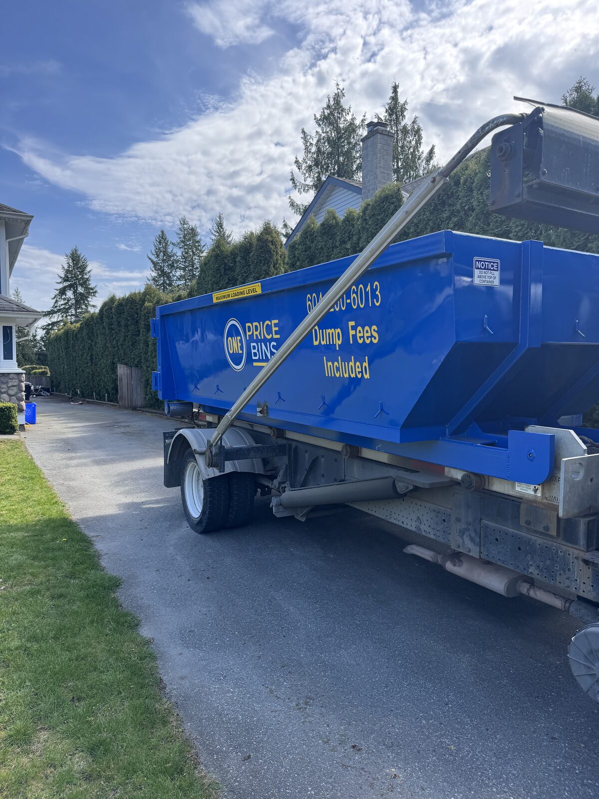 One Price Bins roll-off bin loaded on delivery trailer